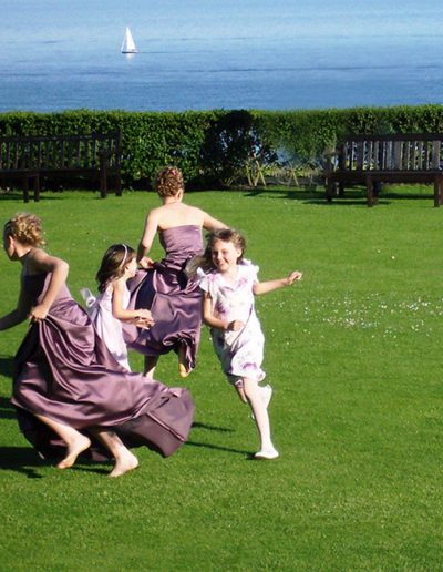 Bridesmaids running on the lawns