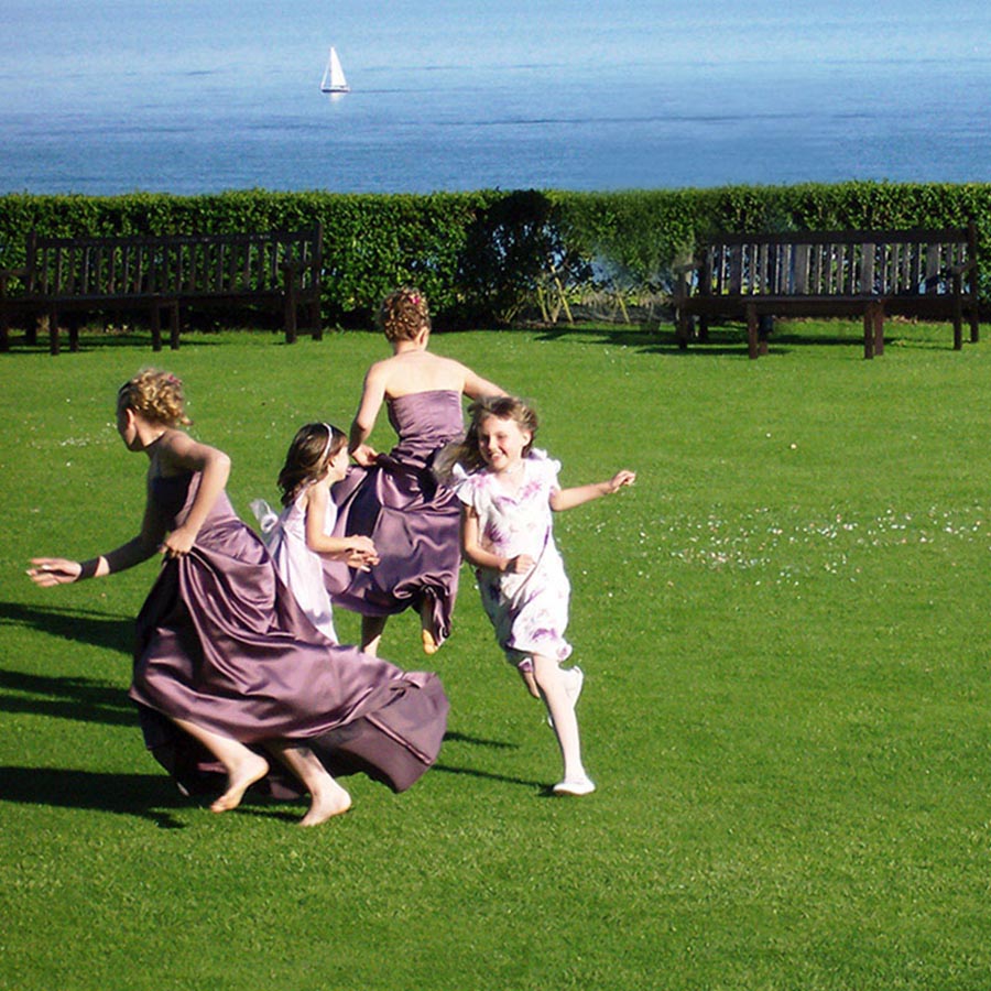 Bridesmaids running on the lawns