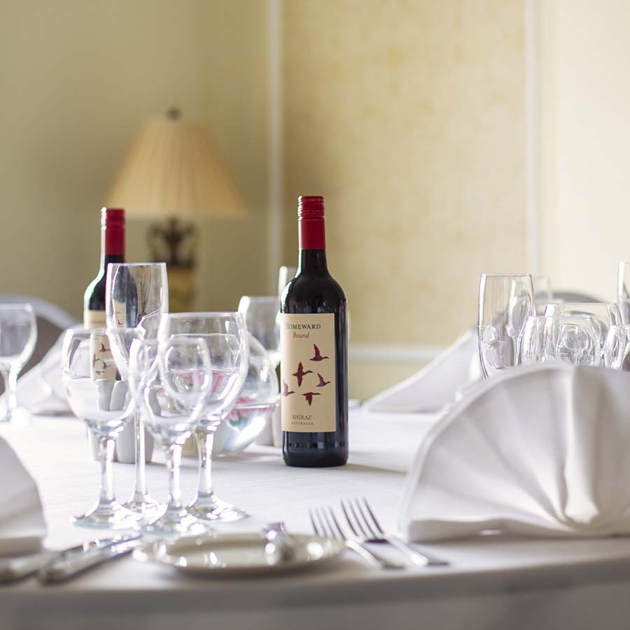 Wine bottle and glasses on private dining table