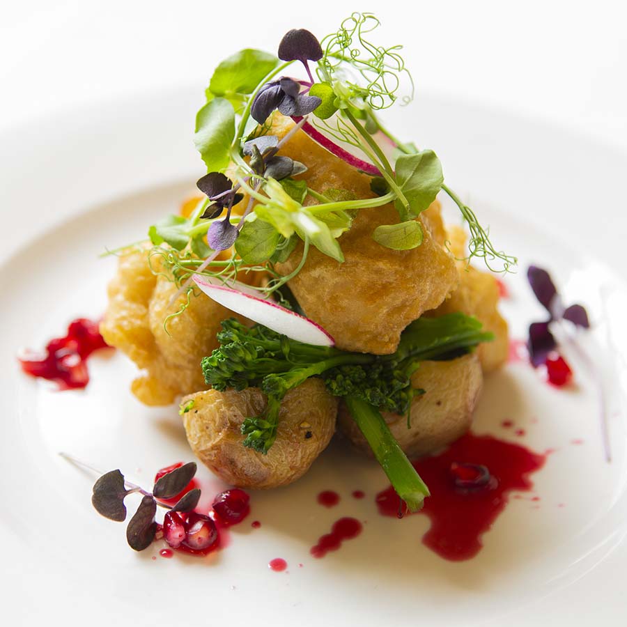 Vegan Cauliflower Beignet served on a white plate