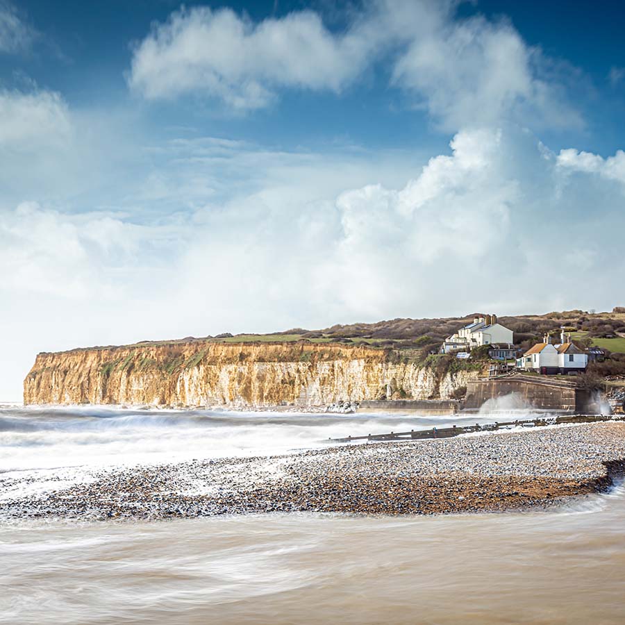 View of Seven sisters cottages from the beach, South Downs